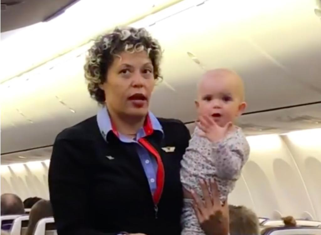 Aeromoza ayuda a pasajera a cuidar de su bebé durante vuelo