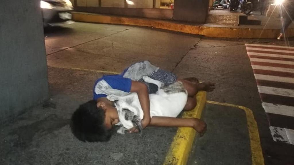 VIRAL: Niño en situación de calle duerme abrazado de su perrito en una banqueta