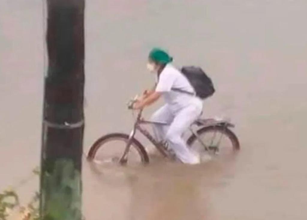 Enfermera cruza calles inundadas en bici para volver a casa del trabajo