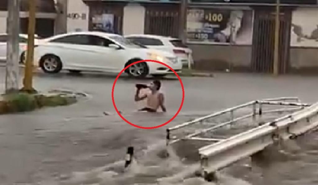 'Ni la lluvia lo detuvo'; hombre se vuelve viral al 'disfrutar' las inundaciones en Culiacán con 'caguama' en mano